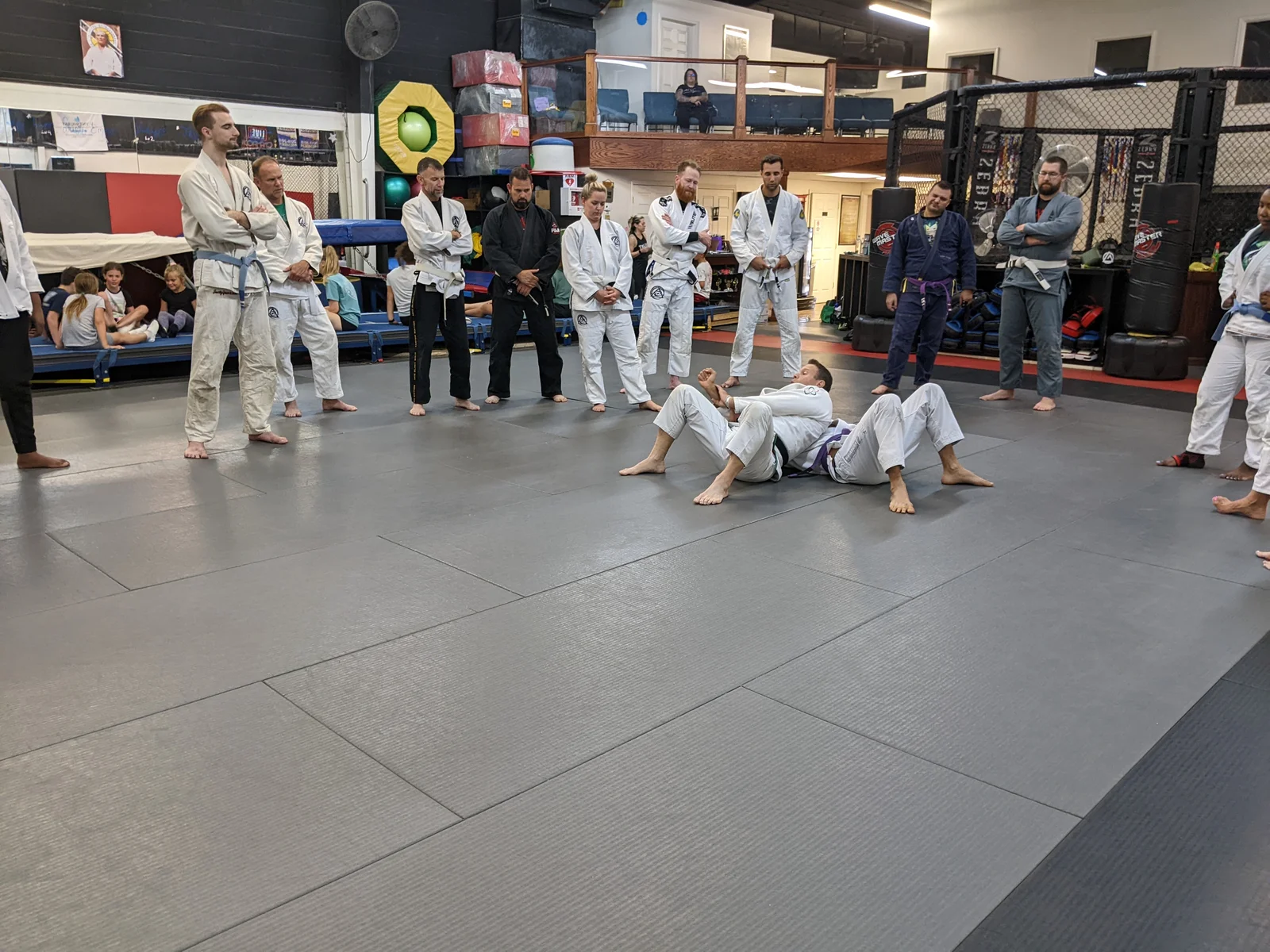An instructor demonstrates Jiu-Jitsu to students at The Edge
